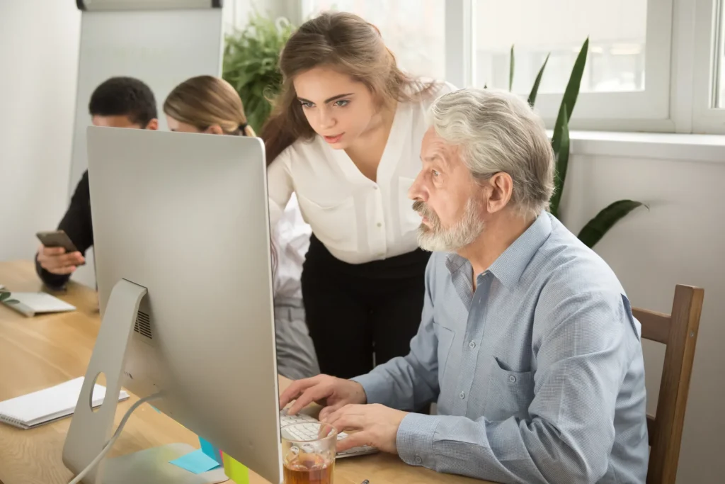 Deux personnes utilisent un ordinateur pour rechercher d'un emploi dans l'Espace Public Numérique Accompagné (EPNA)